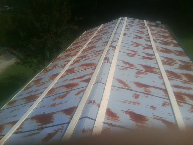 Rusted metal roof panels with new wood purlins before replacement — Storm Damage Roof Repair in Collingswood by Roofing Brothers