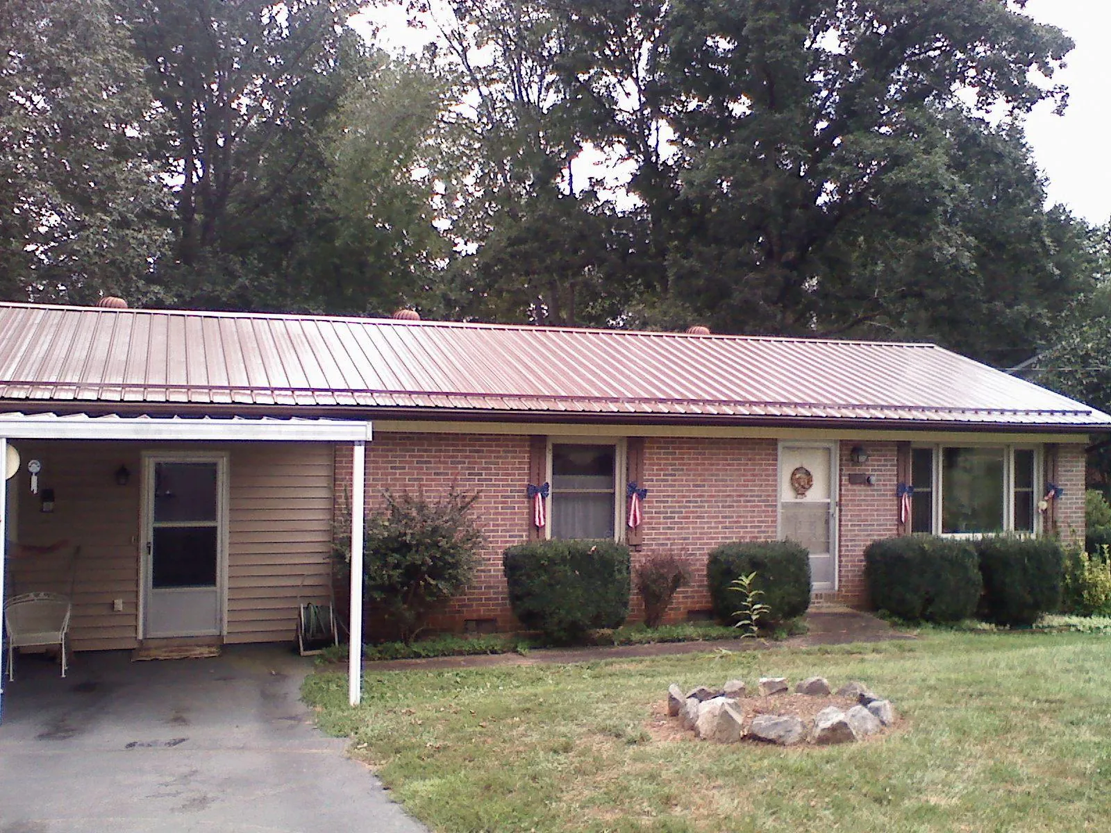 Bronze metal roof and carport on a brick ranch home — Roof Repair work by our crew in Collingswood